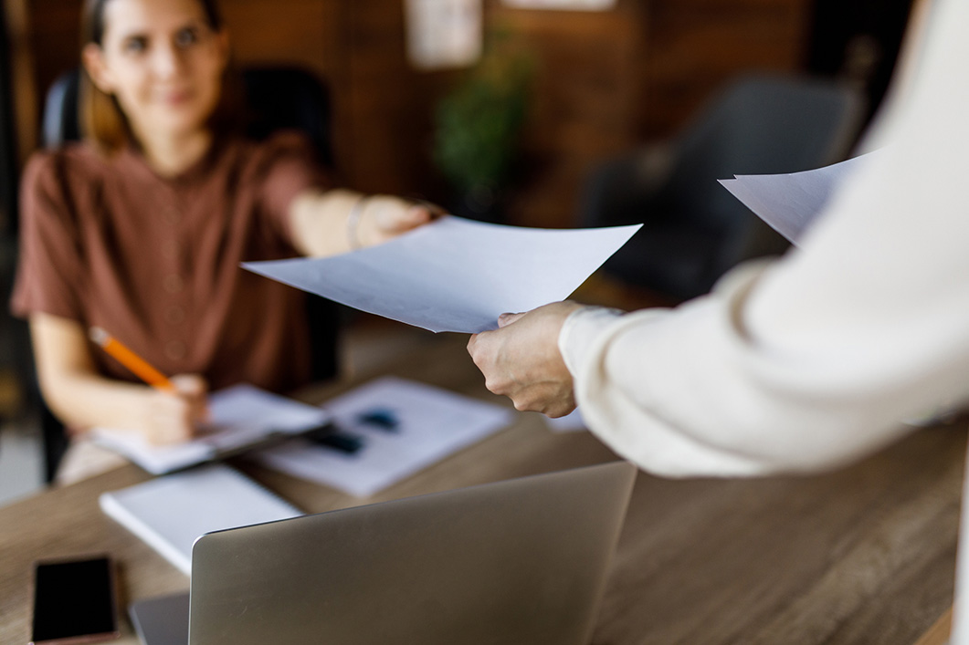 Businesswoman handing her colleague a document