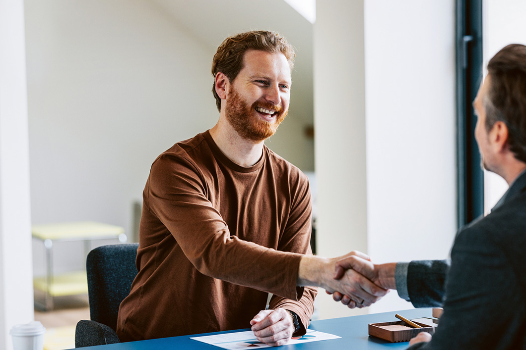 Two Professionals in a Friendly Handshake During a Business Meeting
