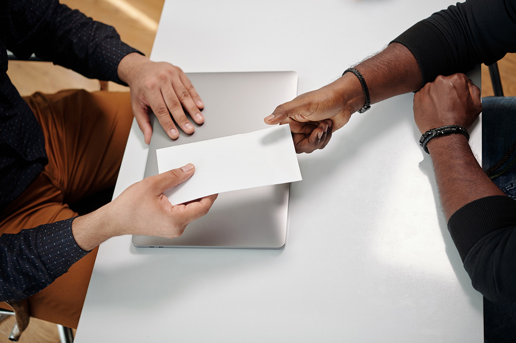 Businessman Giving Envelope with Money