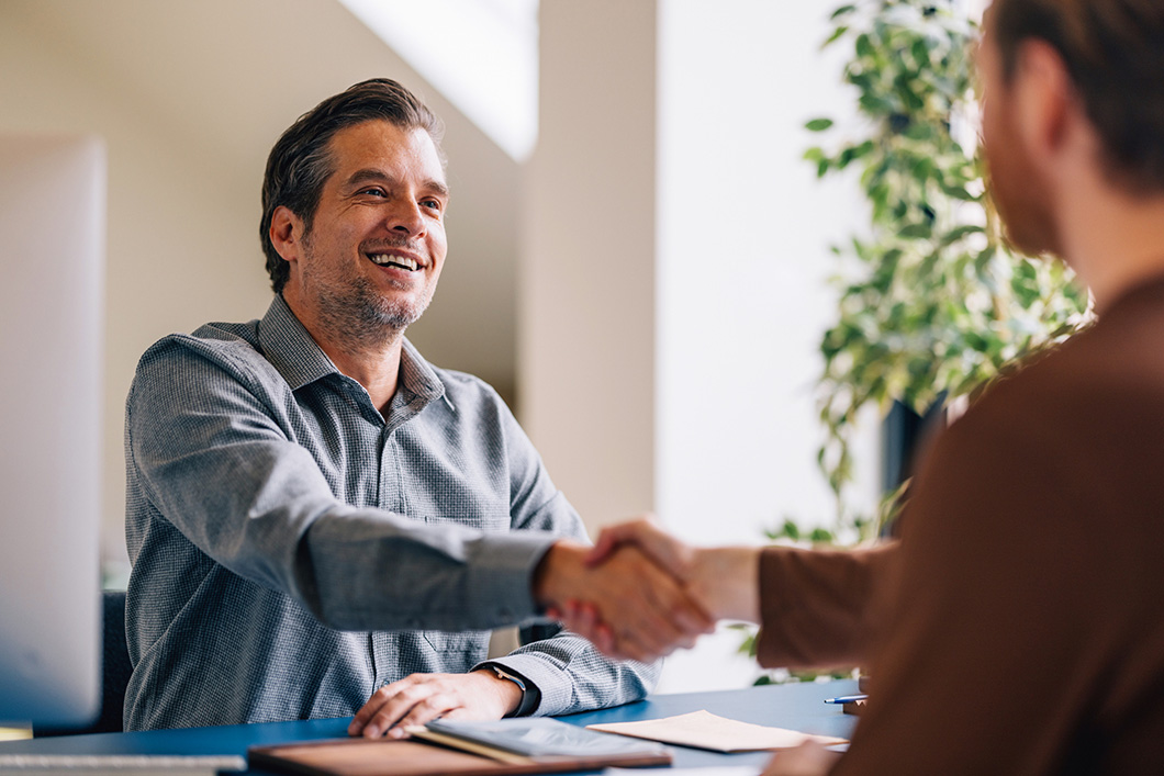 Smiling Businessman Handshaking Partner After Successful Meeting