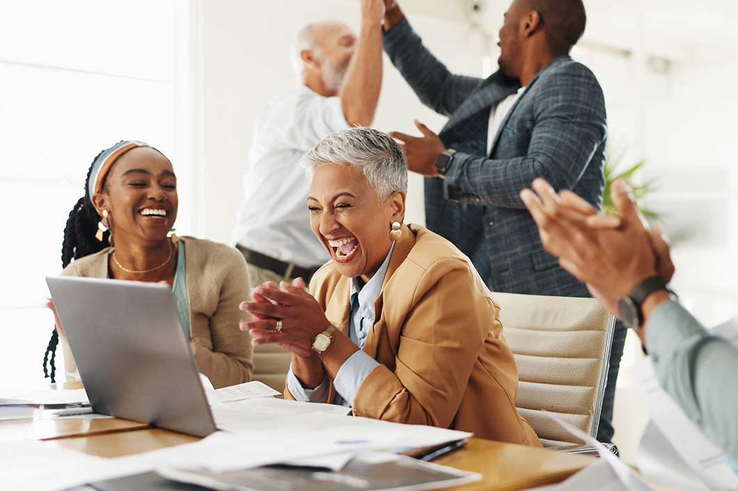 Executive, woman and team with applause by laptop for notification, deal or success in modern office. Group, senior leader and business people by computer for news