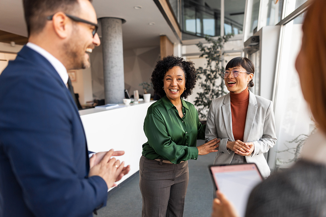 Business Professionals Smiling and Interacting in Modern Office Environment