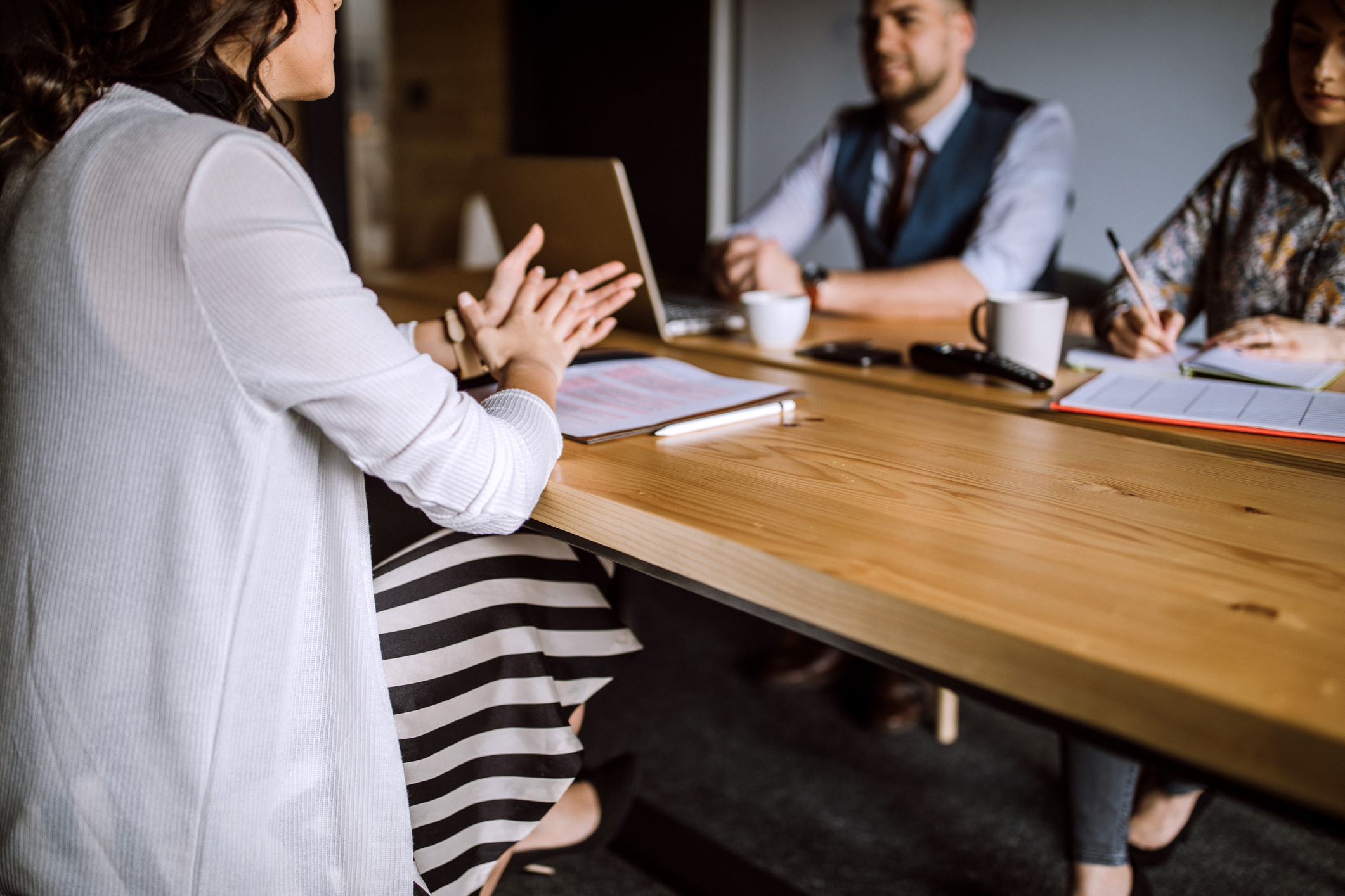 Group of people sitting in board room and having business interview