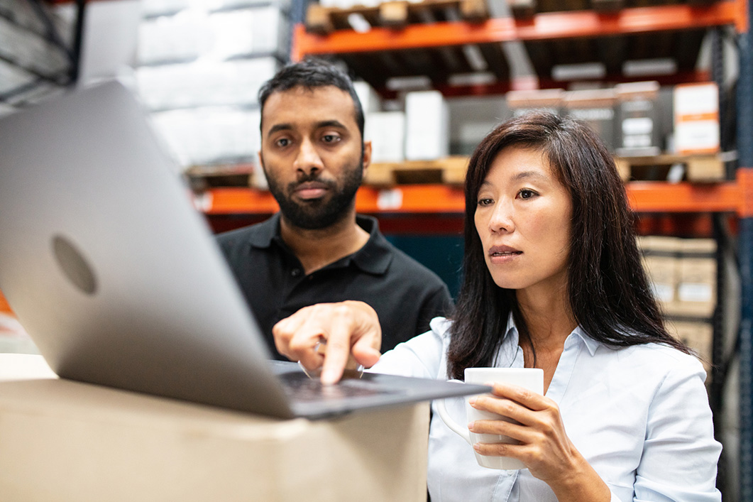 Warehouse staff working on a laptop