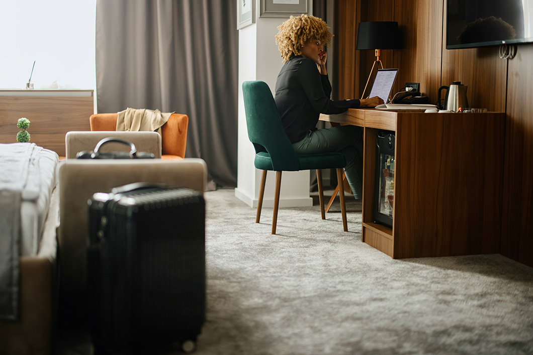 Businesswoman working on laptop in the hotel room