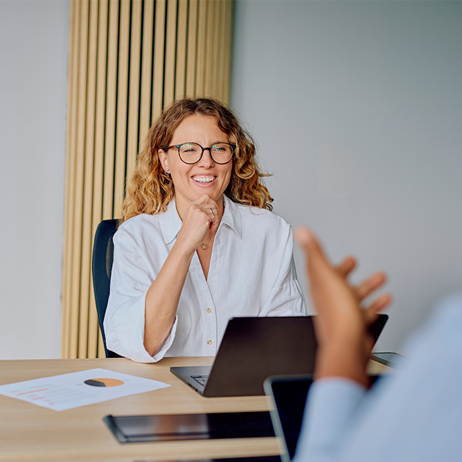 Businesswoman smiling during office meeting