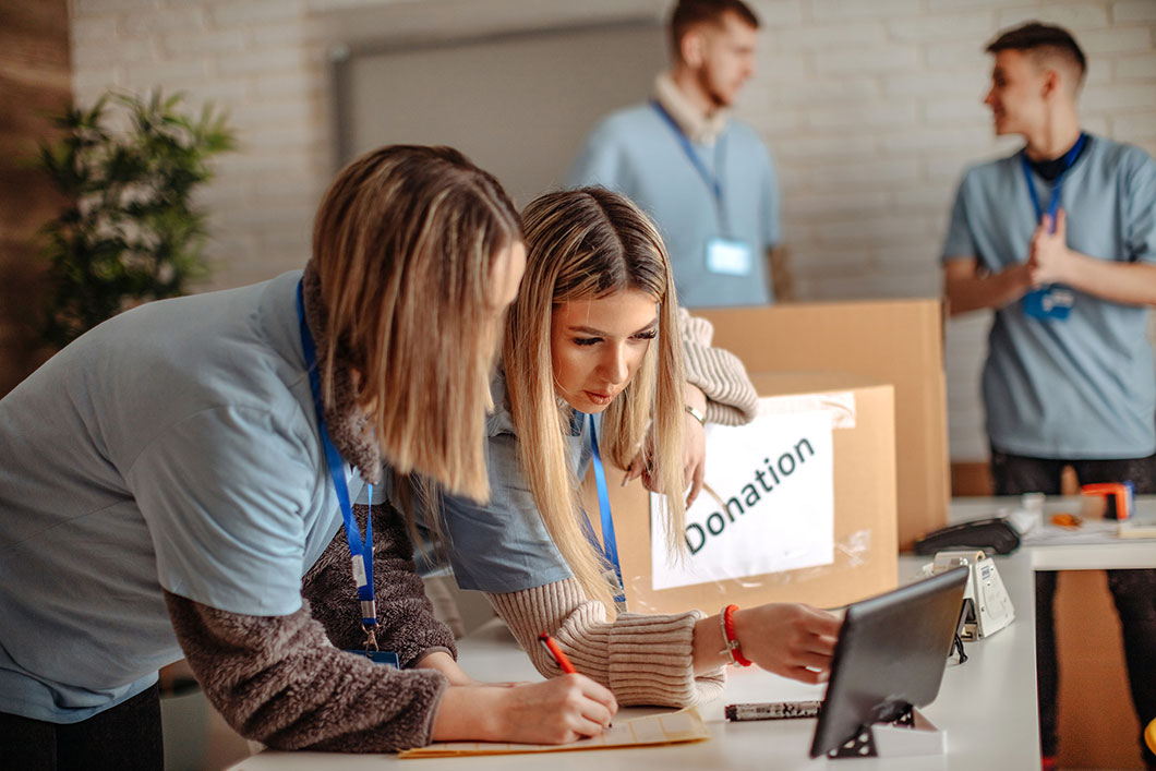 Colleagues discuss work in an office.