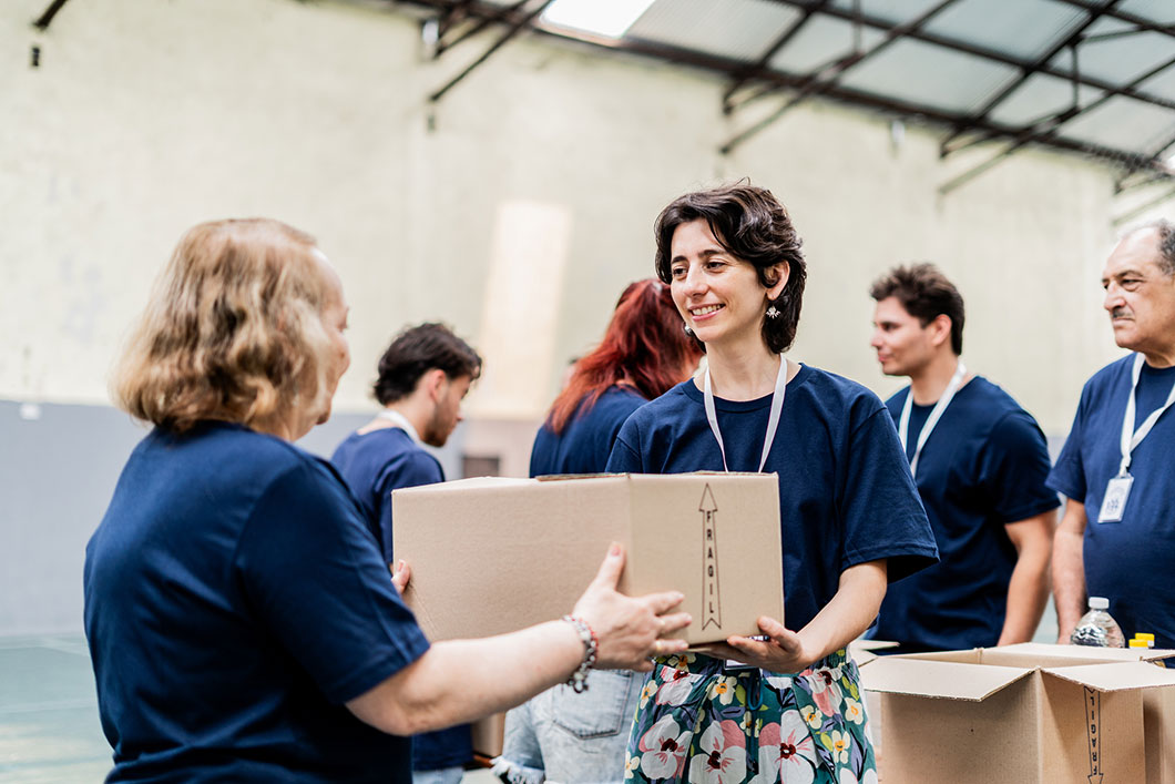 Charity workers hand boxes between them.